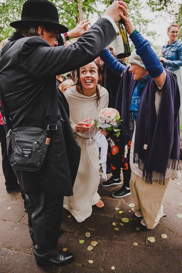 Bride passing through a human tunnel.