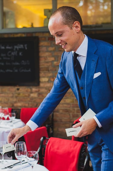 Groom putting down name cards on a table.