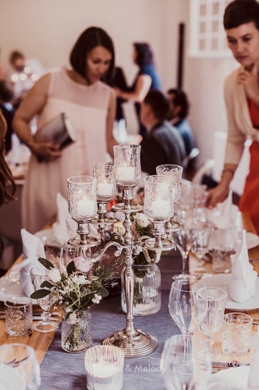 A silver candelabra on a wedding table.