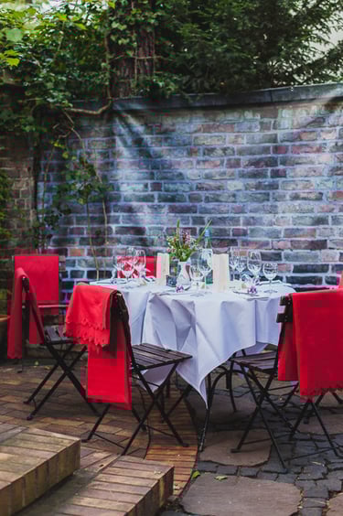 Wedding table setting with red blankets.