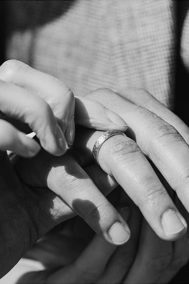 Bride playing with groom's wedding band.