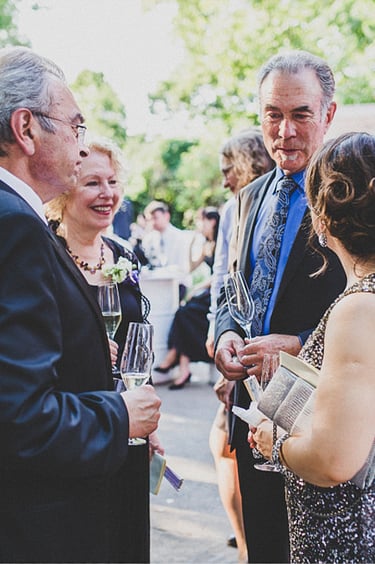 Wedding guests chatting to each other at a wedding reception.