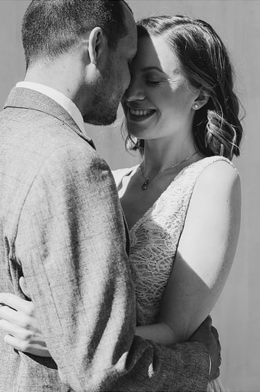 Bride and groom touching their foreheads.