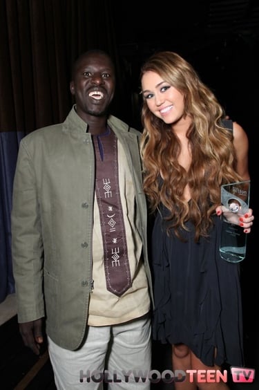 Okello Sam with Global Action Youth Leadership Award Winner Miley Cyrus at the 2011 Global Action Aw