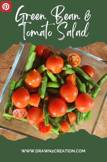 a bowl of green beans and tomatoes on a cutting board