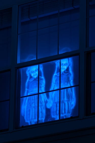 Halloween projector used to create images in window.