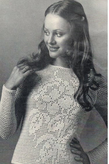 a woman in a white crochet shirt