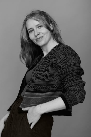 A black and white portrait of a woman wearing a sweater.
