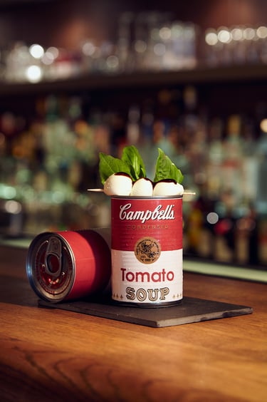 A bloody mary with mozarella and basil served in a can.
