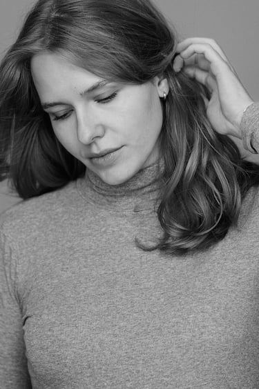 A black and white portrait of a woman in a studio.