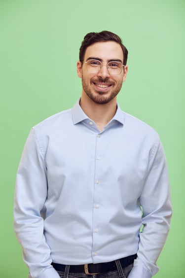 CV portrait of a young man with a green background.