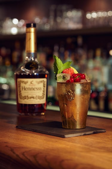 Hennessy cocktail in a metal cup.