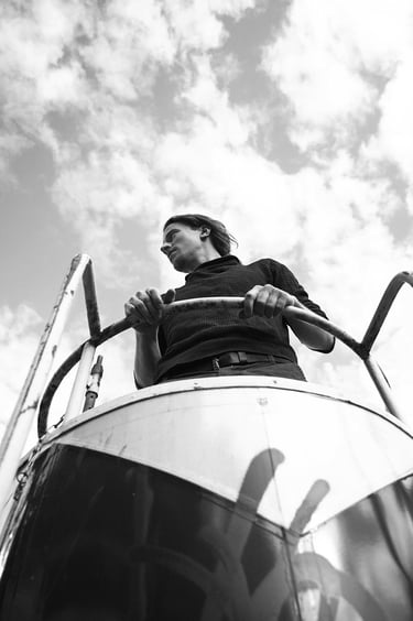A portrait of a man outdoors photographed from the bottom.