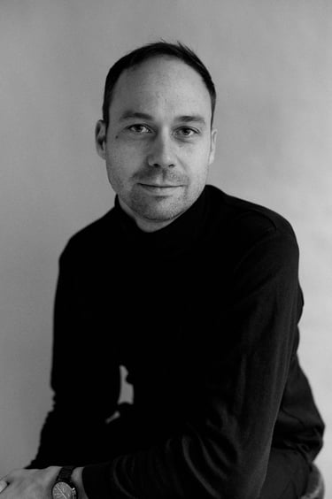 Portrait of a man in a black turtleneck.