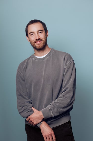 Portrait of a man with a blue background.