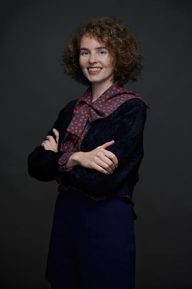 A studio portrait of a young woman.