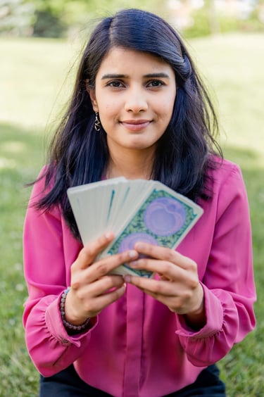 Dr. Rio Kashyap holding a stack of Tarot cards in her hands