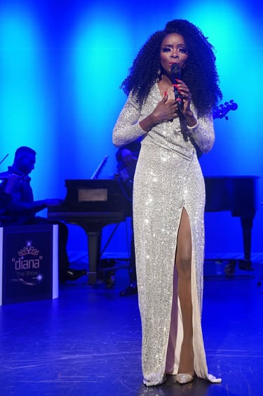 a woman in a white dress standing in front of a microphone