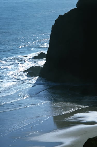 A person walking on Anawhata Beach; Anawhata, New Zealand - Fine art photograph