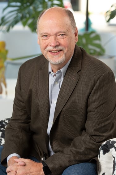 a man in a suit and tie smiling