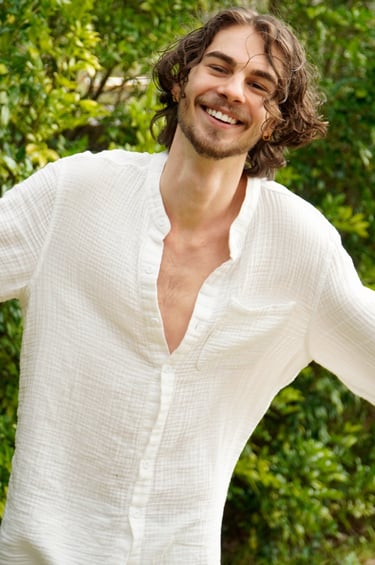 a man with a beard and a white shirt