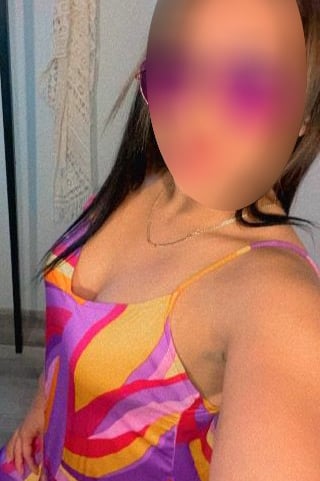 a woman with a large breast breast, wearing a colorful dress