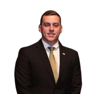 a man in a suit and tie standing in front of a black background