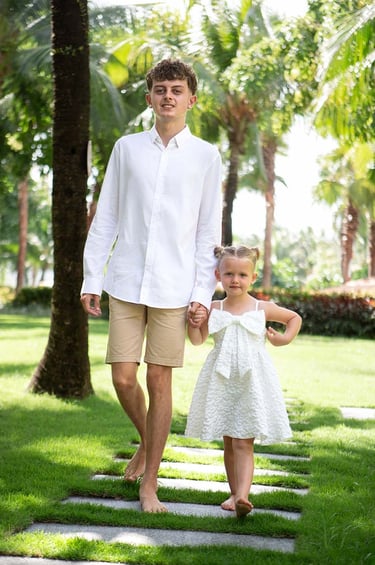 Brother and sister walking through Premier Residences Phu Quoc garden