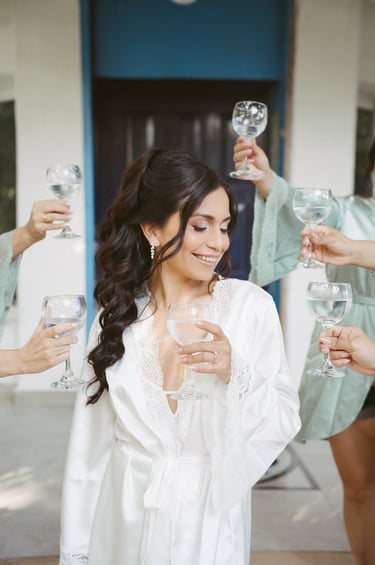 a woman in a robe is holding a glass of wine