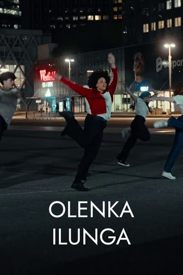 Olenka Ilunga and a group of modern dancers performing a choreography at night in a city square.
