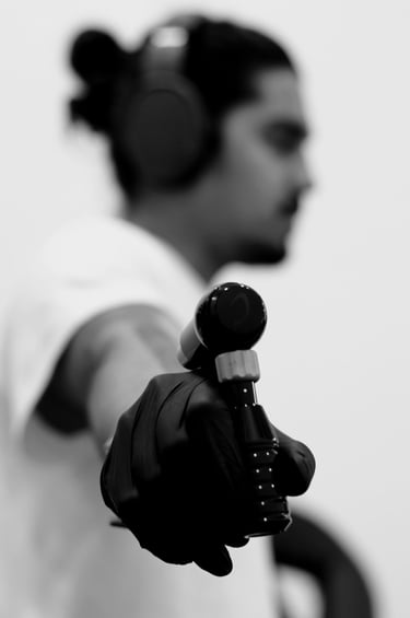 Photo of a Tattoo Artist posing with a Tattoo Machine