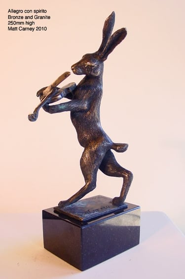 a statue of a rabbit playing a violin