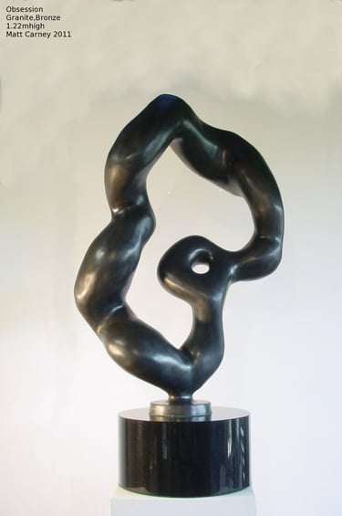 an abstract bronze sculpture on a black granite base