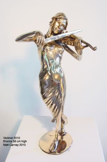 a statue of a woman playing violin