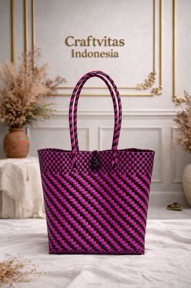 Handwoven plastic tote bag with Indonesian batik diagonal pattern in pink and black, sustainable handmade bag