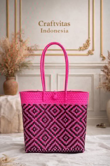 Pink and black handwoven plastic tote bag with geometric batik pattern, handmade Indonesian woven bag
