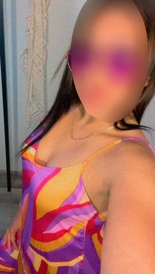 a woman with a large breast breast, wearing a colorful dress