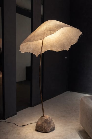 Modern outdoor floor lamp beside a lounge chair, creating a calm balcony lighting atmosphere.