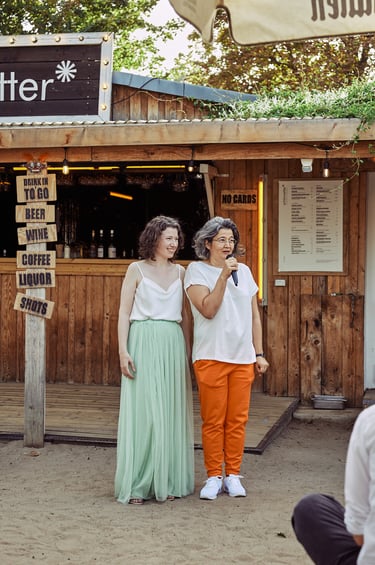 Lesbian brides giving a speech at their reception at Schönwetter.