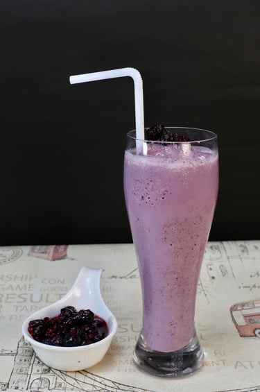 berry colored drink on tall crystal clear glass
