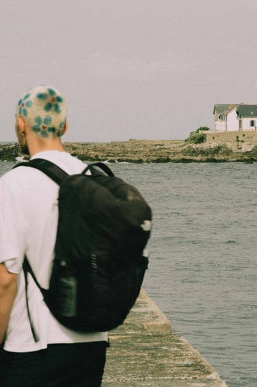 a man with a backpacker on a pier