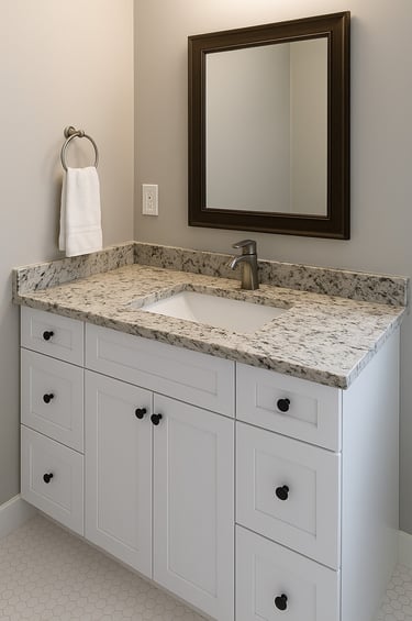 compact white vanity, euro-style with marble countertop and a mirror
