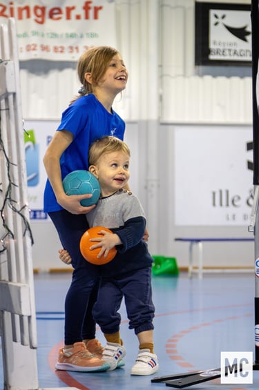 a woman and a young child playing with a ball