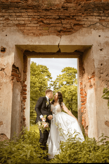 a bride and groom kissing in a doorway
