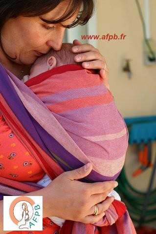 femme portant son bébé en écharpe