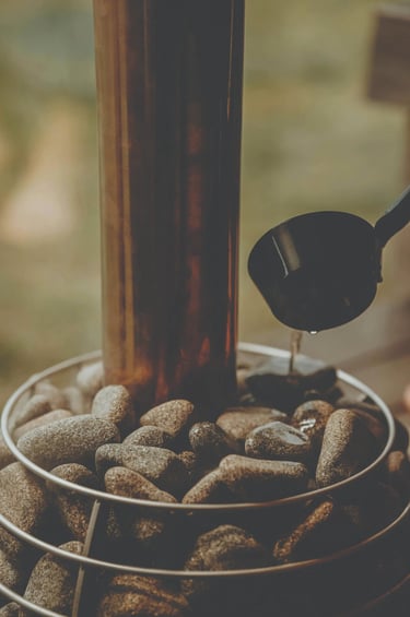 Close-up of Scandinavian sauna stove with hot stones in an Outdoor sauna Ontario interior