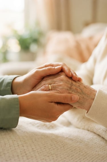Close-up of a caregiver's hand gently holding an elderly person's hand, warm morning window light, rich cream and sage tones, shallow depth of field, 35mm