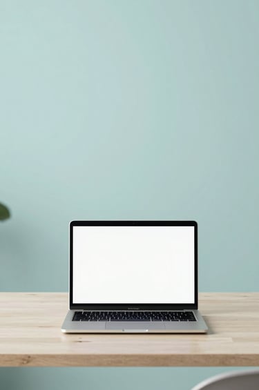 A high-resolution, wide shot of a modern, minimalist studio. A sleek laptop sits on a light desk, with a wall featuring a soft #A7C5C3 hue in the background. The lighting is bright and airy, emphasizing clarity and functional elegance.
