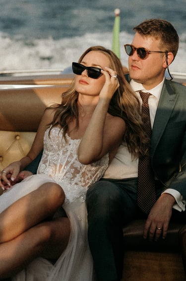 a man and woman sitting on a boat on Lake Como