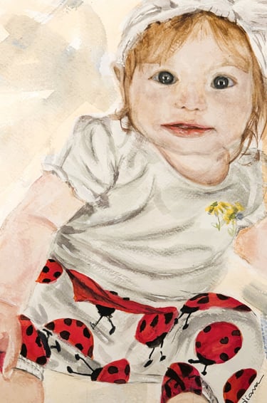 a painting of a baby's face wearing ladybug pants